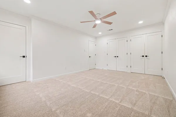 an empty room with a ceiling fan
