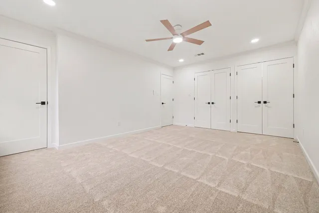 an empty room with a ceiling fan