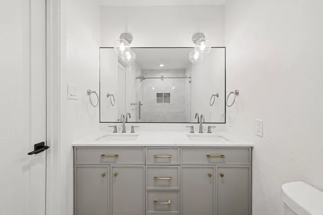 a bathroom with a sink vanity and a mirror