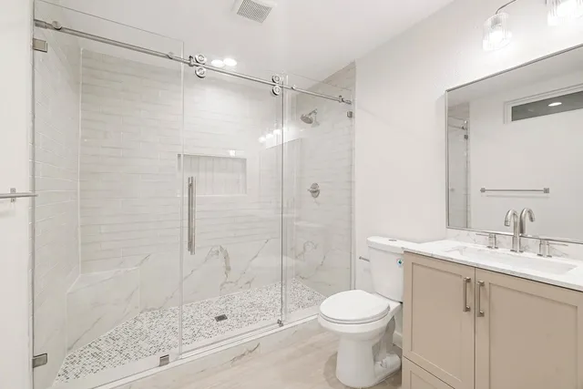 a bathroom with a sink toilet and shower