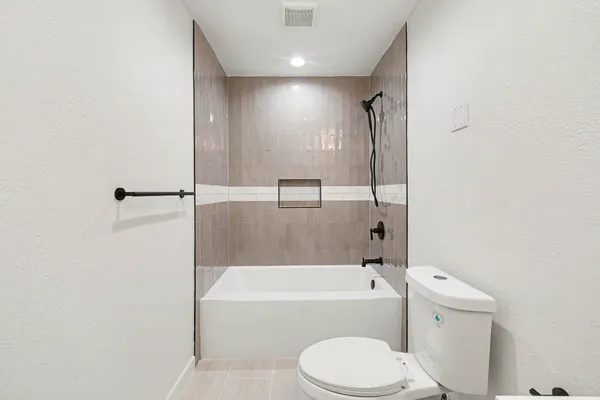 a bathroom with a toilet and a bathtub