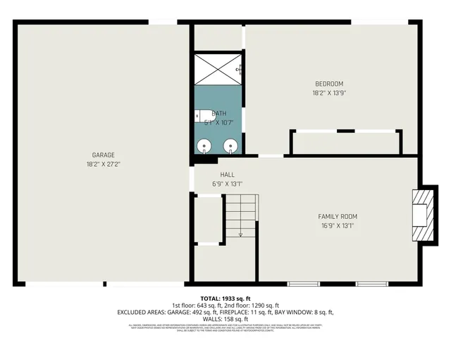 a picture of a room with a white wall and a large white refrigerator