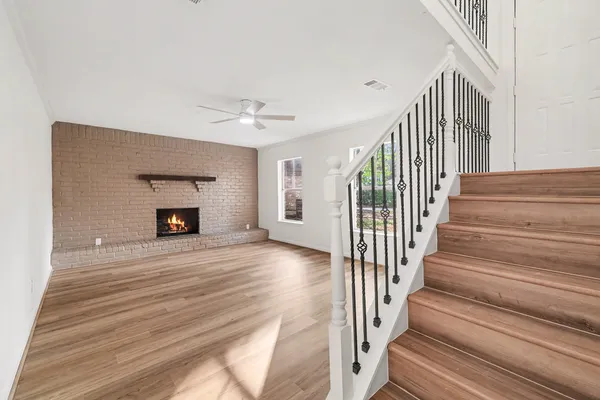 a view of staircase with white walls and a rug