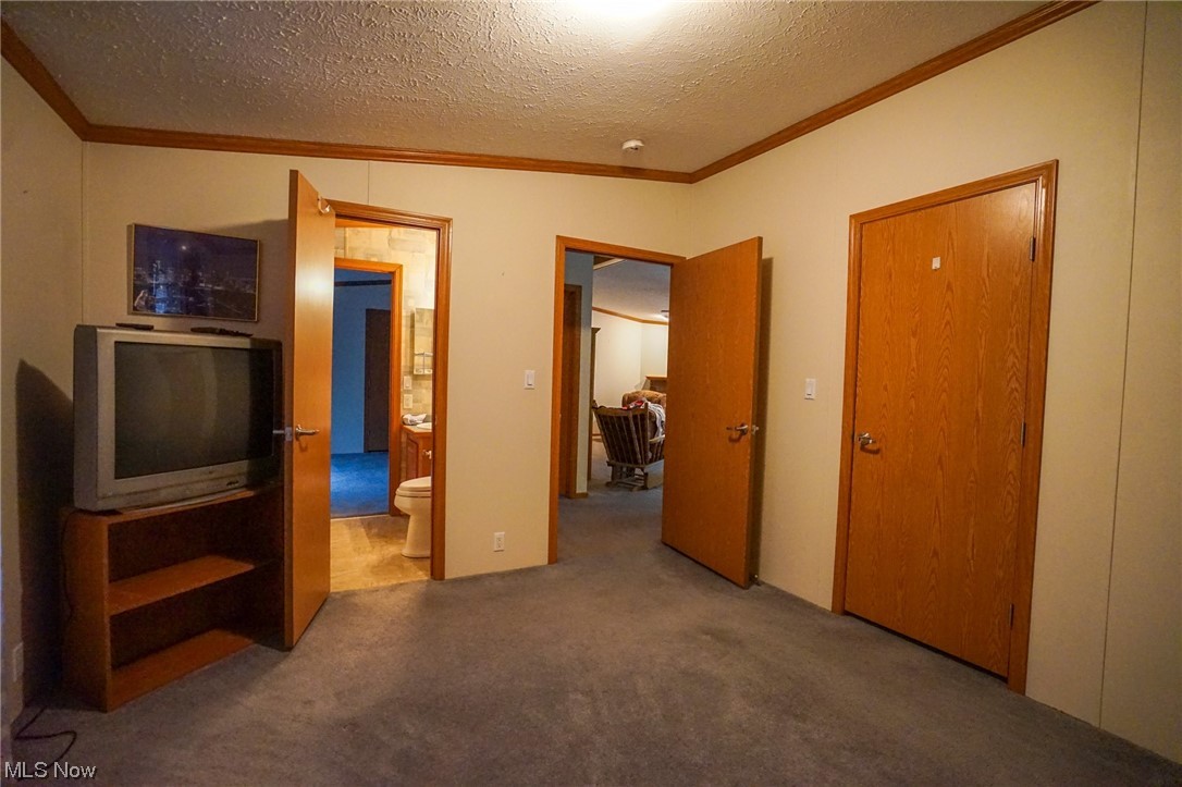 37632 Sheepskin Ridge Road Lower Salem, OH 45745 - Photo 15 of 30 Unfurnished bedroom with a textured ceiling and dark colored carpet