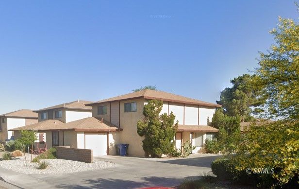 1004 West Perdew Avenue Ridgecrest, CA 93555 - Photo 1 of 14 a front view of a house with garden