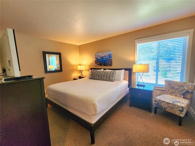 a bedroom with a bed and window