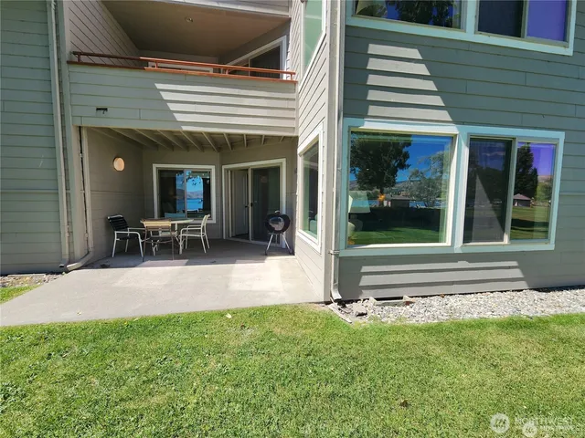 a view of a house with backyard porch and sitting area