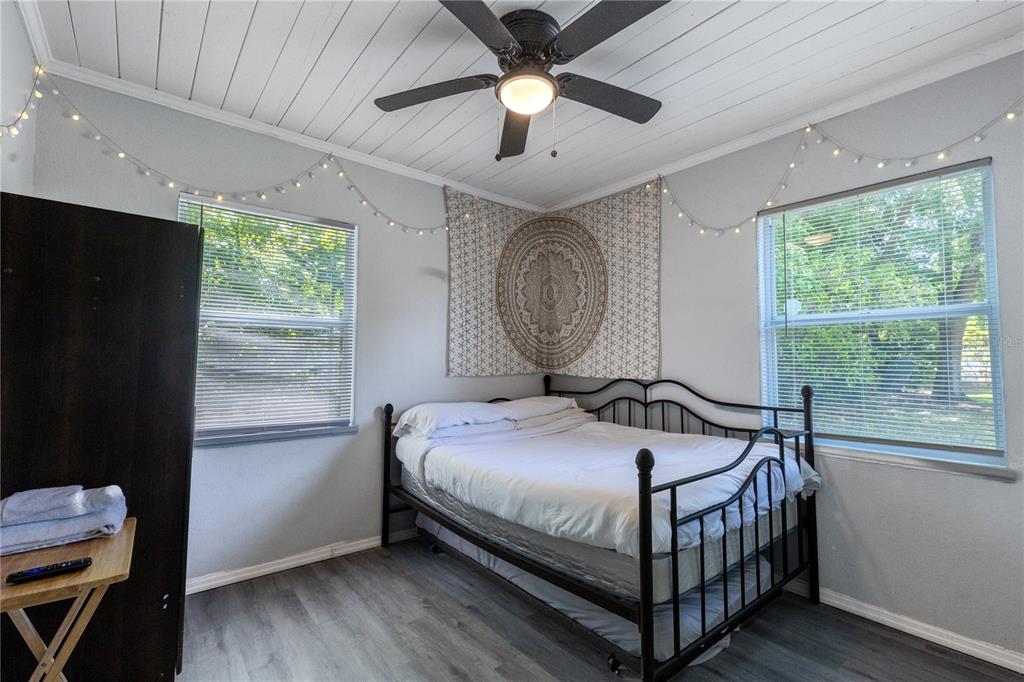 123 Oconee Street Lakeland, FL 33805 - Photo 17 of 25 a bedroom with a bed and a chandelier