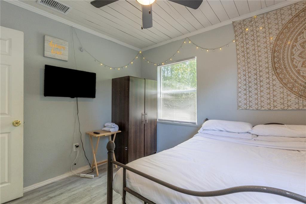 123 Oconee Street Lakeland, FL 33805 - Photo 19 of 25 a bedroom with a bed and a flat screen tv