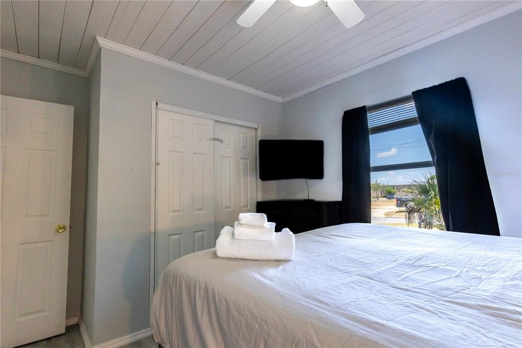 123 Oconee Street Lakeland, FL 33805 - Photo 22 of 25 a bedroom with a bed and a flat tv screen on dresser