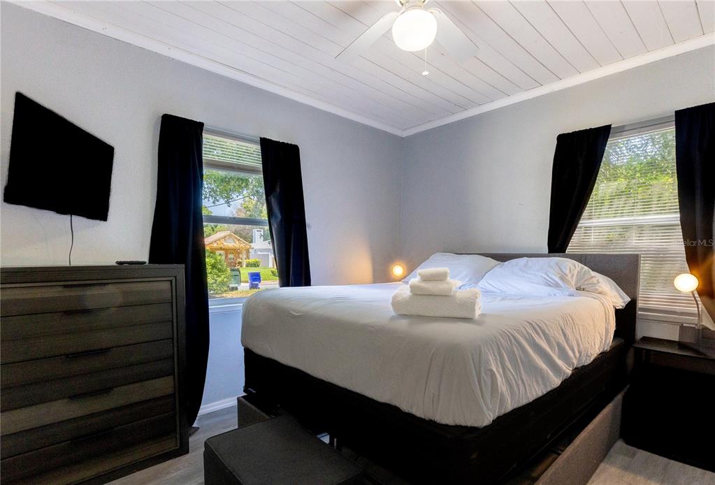 123 Oconee Street Lakeland, FL 33805 - Photo 23 of 25 a bedroom with a bed and a flat screen tv