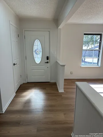 a view of room with window and wooden floor