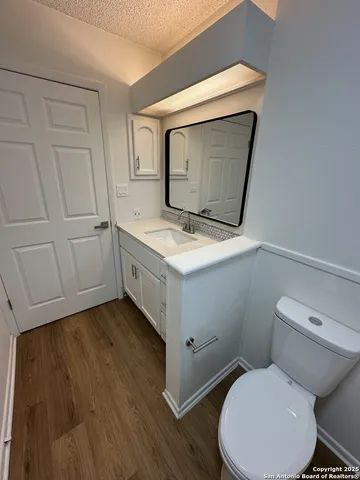 a bathroom with a toilet sink and mirror