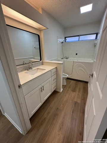 a bathroom with a double vanity sink and mirror