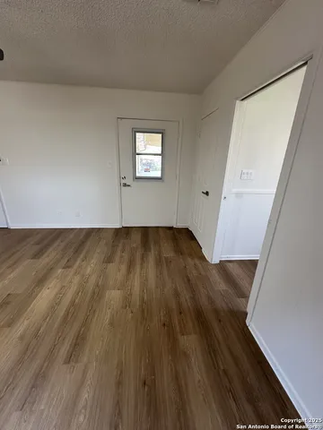 a view of a room with wooden floor and staircase