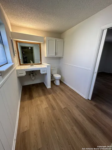 a view of a room with wooden floor and window