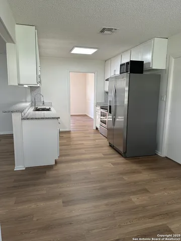 a kitchen with stainless steel appliances a refrigerator and a stove