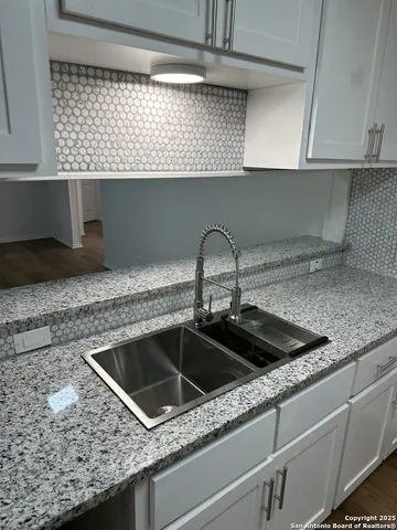 a kitchen with a sink and cabinets