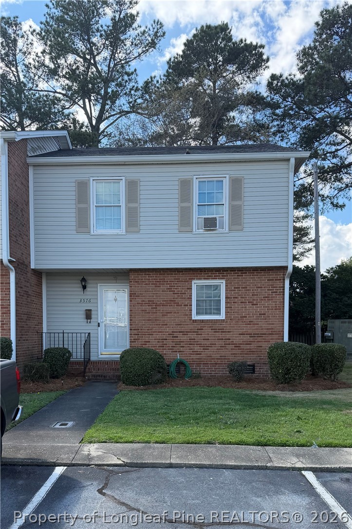 3576 Fayetteville Road Lumberton, NC 28358 - Photo 1 of 5 a brick house that has a small yard and large trees
