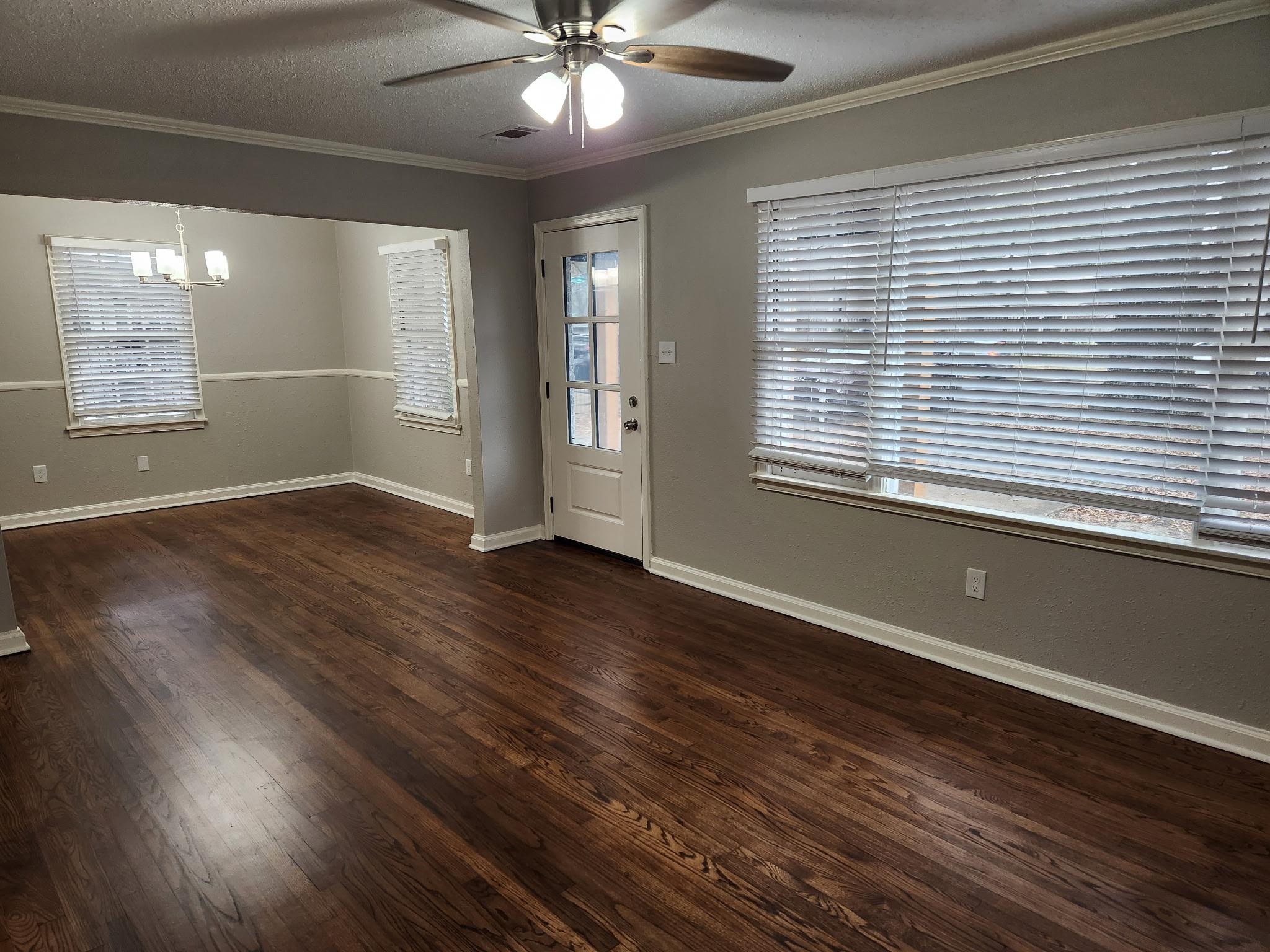 866 Colonial Road Memphis, TN 38117 - Photo 5 of 15 Entryway featuring a textured ceiling, a ceiling fan, dark wood-type flooring, crown molding, and a chandelier