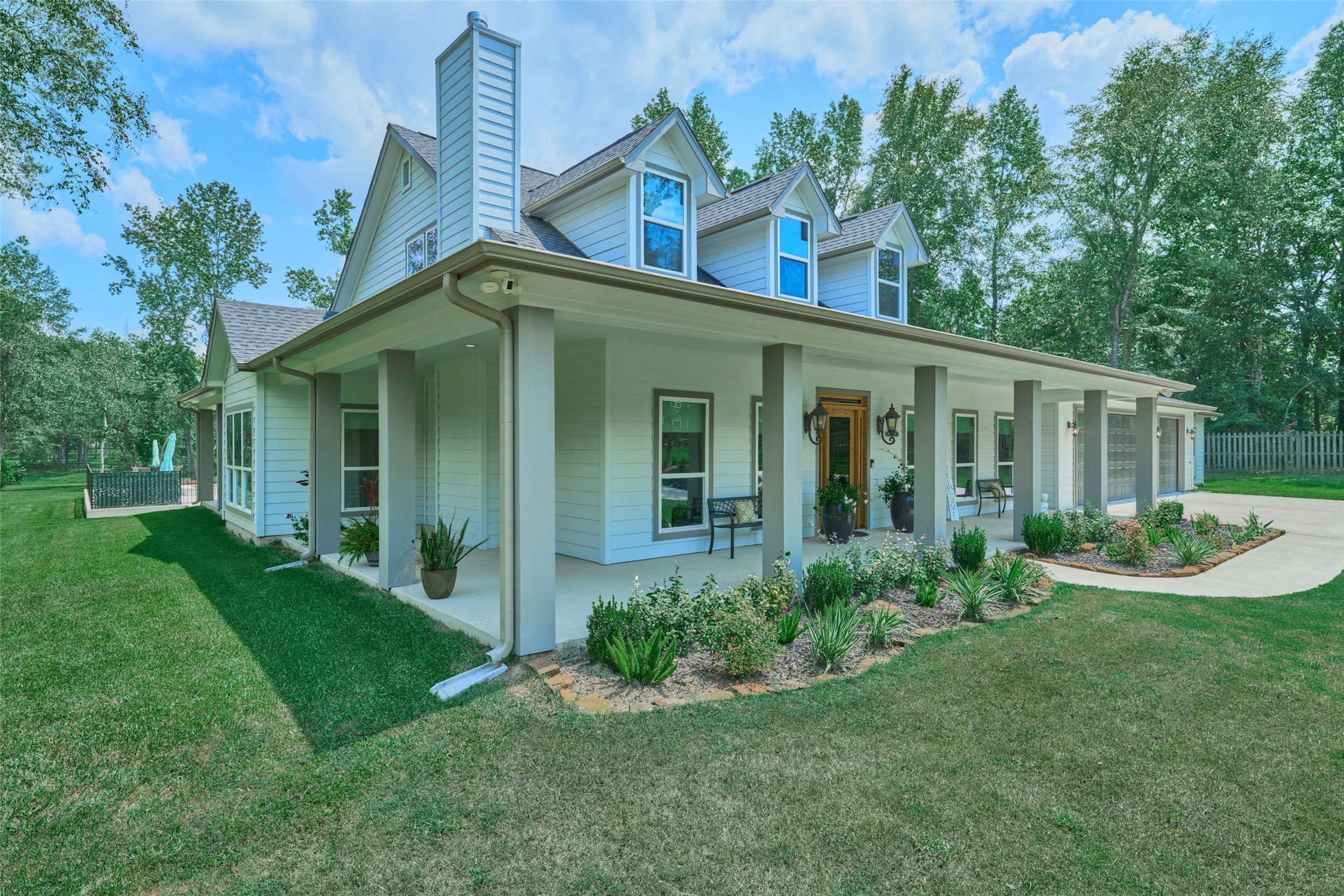 2218 Honea Egypt Road Magnolia, TX 77354 - Photo 4 of 50 Discover the allure of this delightful home, boasting an expansive 1,800 sqft wraparound porch perfect for relaxation and entertaining.