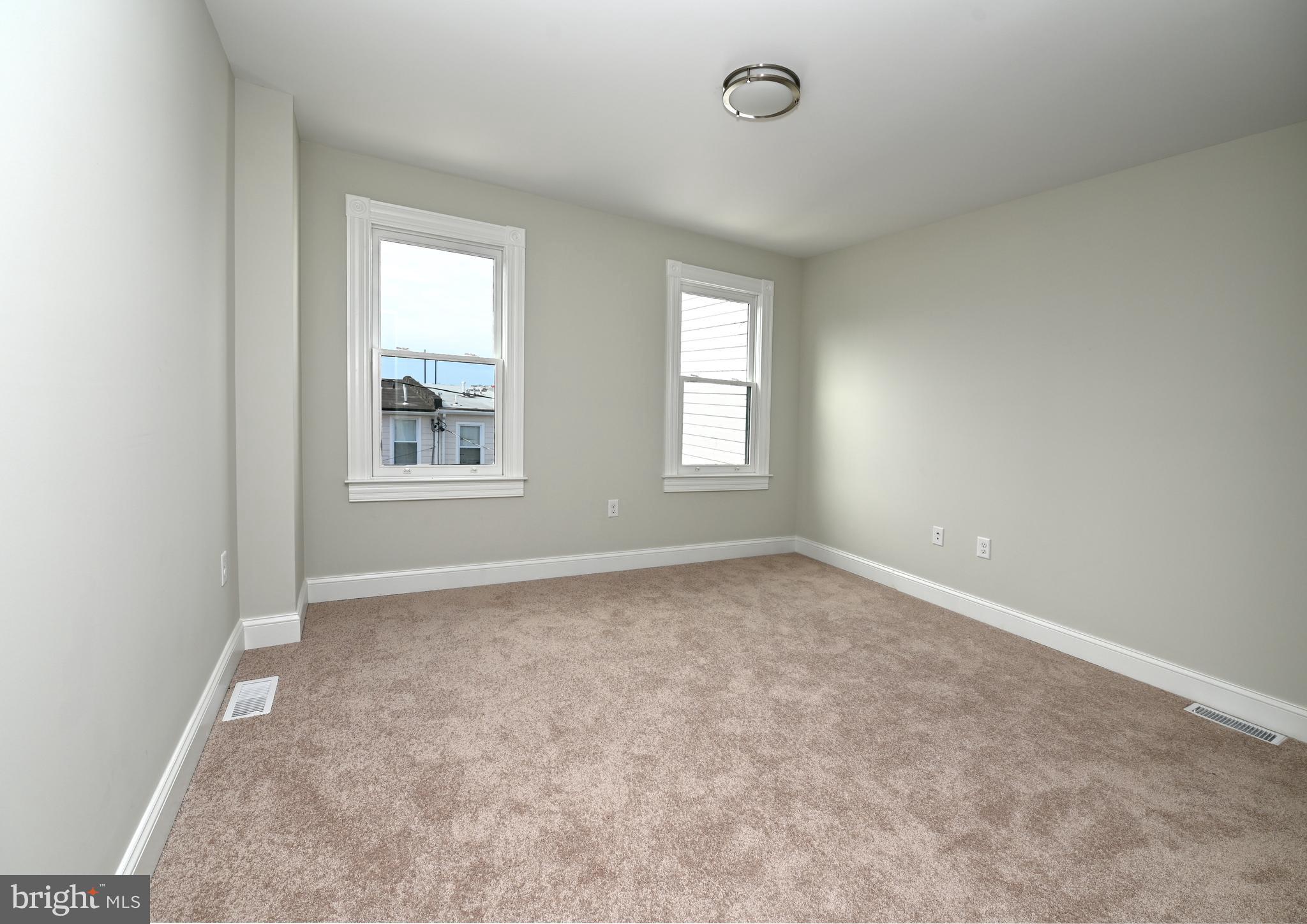 2245 East Biddle Street Baltimore, MD 21213 - Photo 12 of 14 an empty room with windows