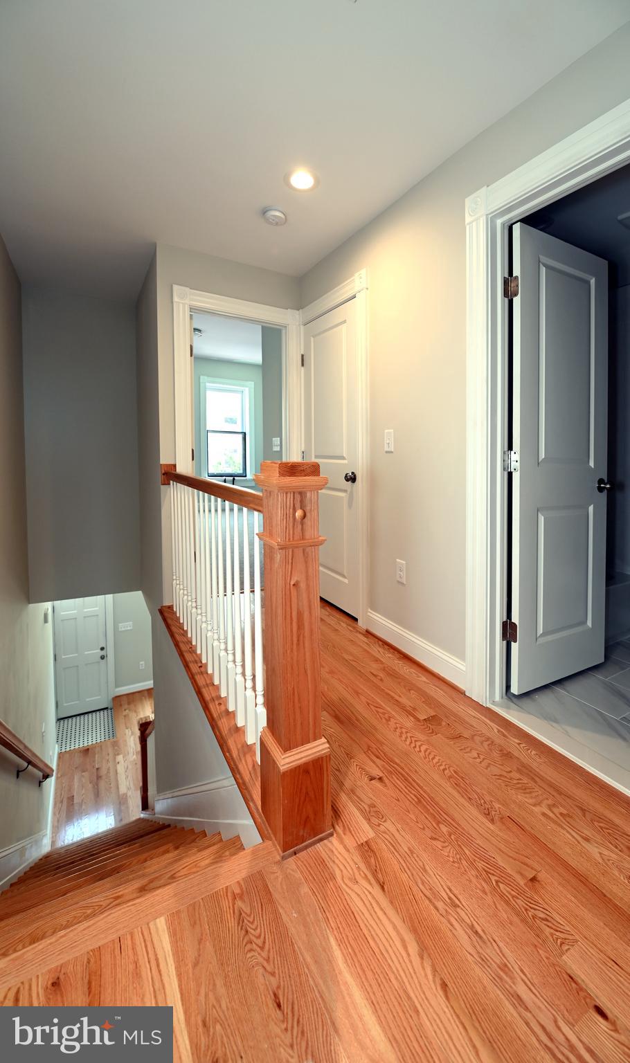 2245 East Biddle Street Baltimore, MD 21213 - Photo 14 of 14 a view of a bedroom with wooden floor and a window