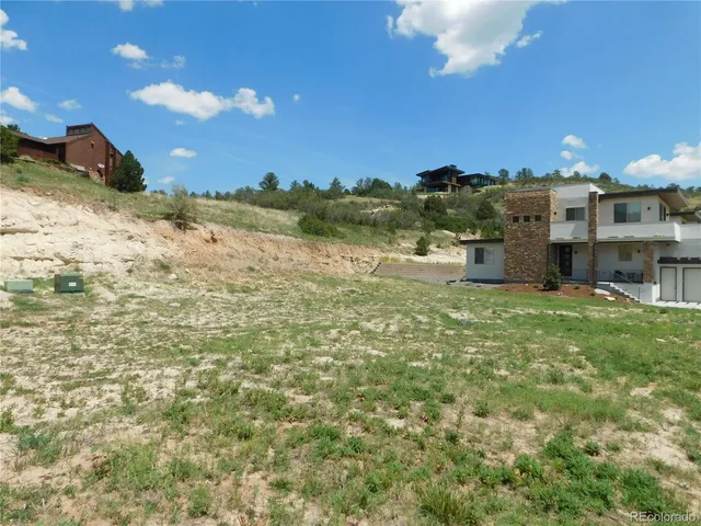 a view of a wooden door with a bench in the background