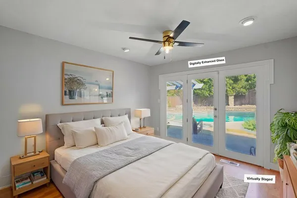 a bedroom with a balcony a bed and a painting on the wall