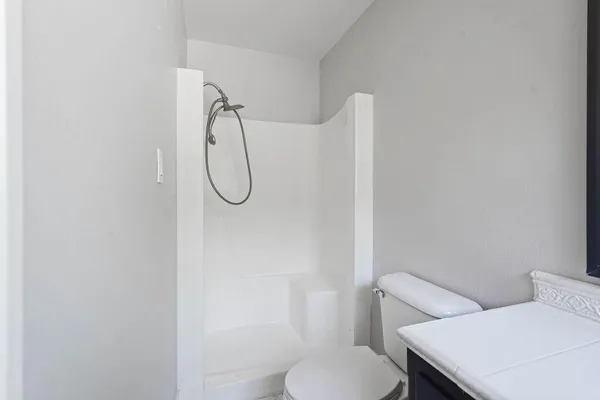 a white toilet sitting next to a bathroom sink