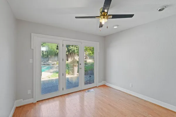 a view of room with window and wooden floor