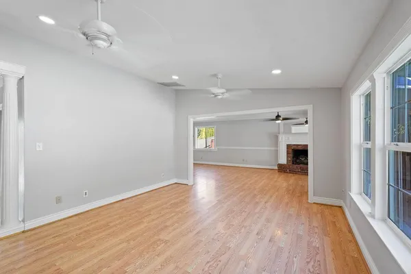 wooden floor in an empty room with a window