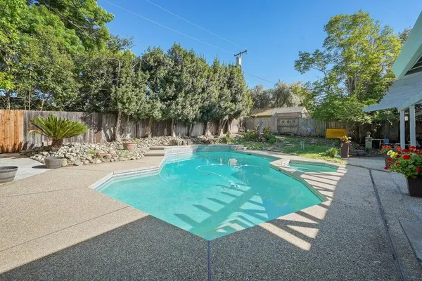 a view of a swimming pool with a patio