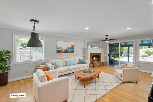 a living room with furniture fireplace and window