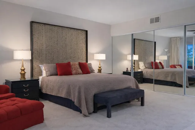 a bedroom with bed and a lamp