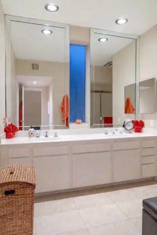 a bathroom with a tub sink and mirror