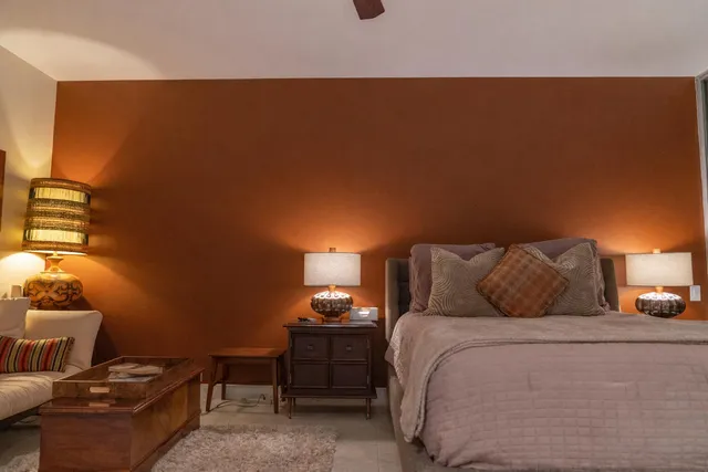 a bed room with a bed and a night stand