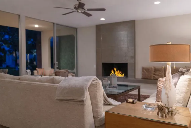 a living room with fireplace furniture and a lamp