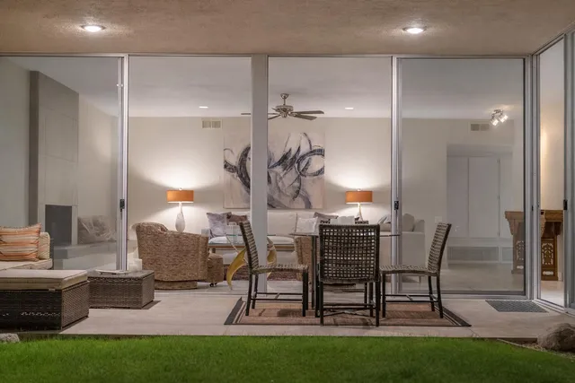 a view of a livingroom with furniture and a table in it