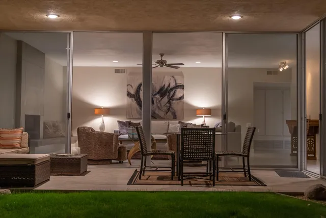 a living room with furniture and a lamp