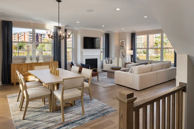 a living room with fireplace furniture and a large window