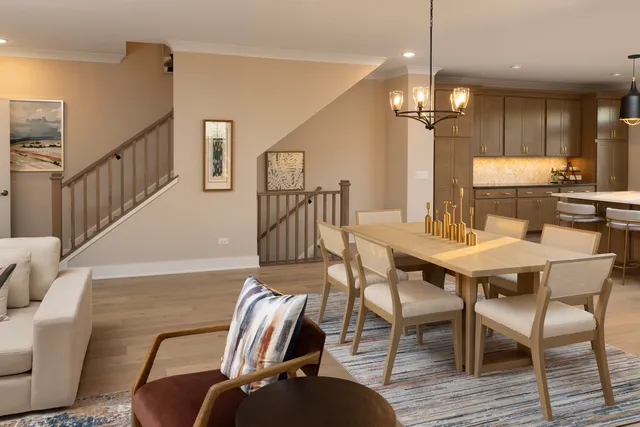 a view of a dining room with furniture wooden floor and chandelier