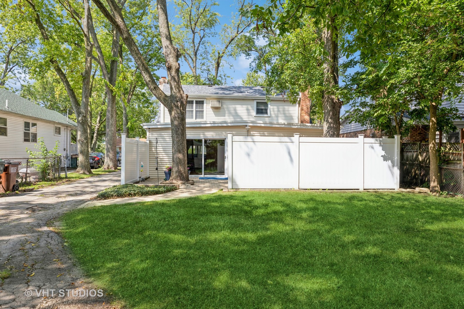 1345 Hickory Road Homewood, IL 60430 - Photo 24 of 28 a view of a white house with a big yard and large tree