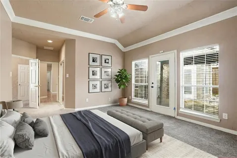 a bedroom with a large bed and a chandelier