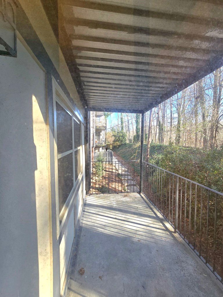 6851 Roswell Road Sandy Springs, GA 30328 - Photo 19 of 19 a view of a porch with wooden floor and a potted plant