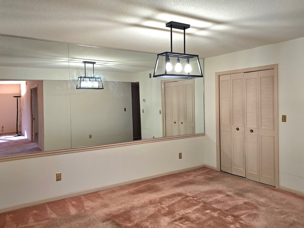 6851 Roswell Road Sandy Springs, GA 30328 - Photo 6 of 19 a view of empty room with wooden floor and chandelier