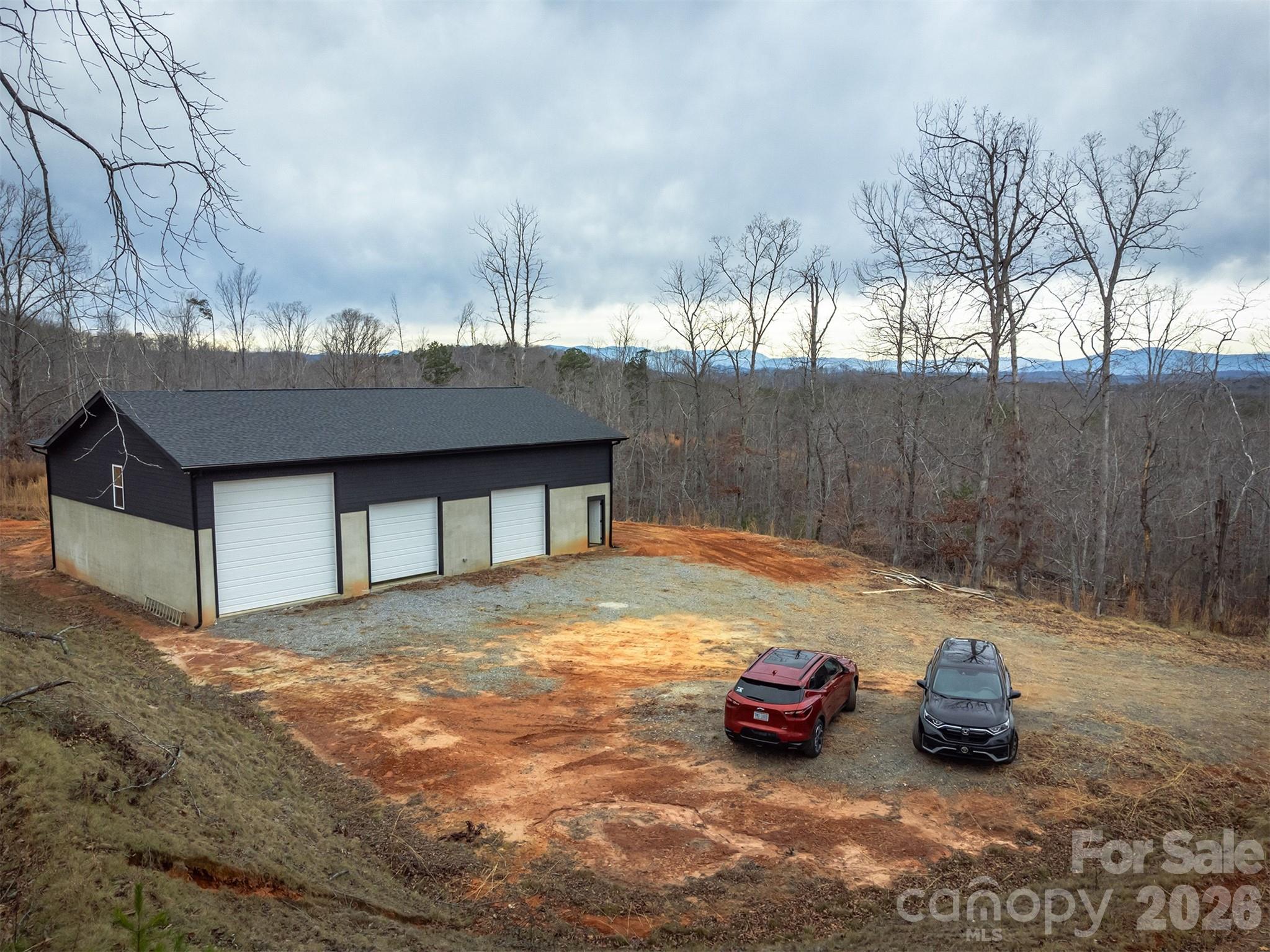 6800 Gold Mine Road Morganton, NC 28655 - Photo 10 of 30 a backyard of a house with fire pit and couches and wooden fence