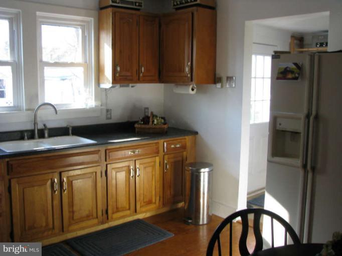 5030 Bethlehem Road Preston, MD 21655 - Photo 9 of 23 a kitchen with stainless steel appliances granite countertop a sink a refrigerator and a granite counter tops with a window