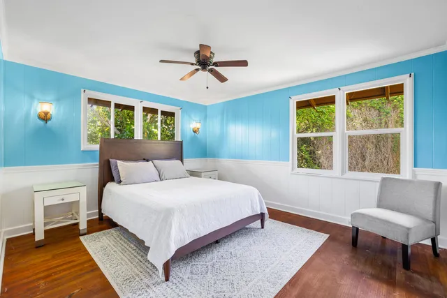 a bedroom with a large bed and a window