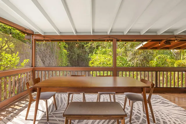 a view of a chairs and table in the balcony